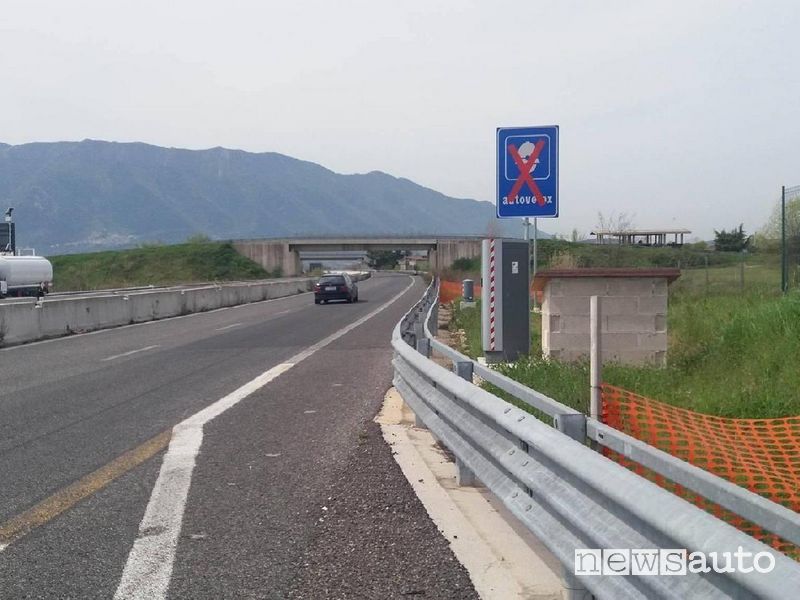 Fixed speed camera marked with a sign